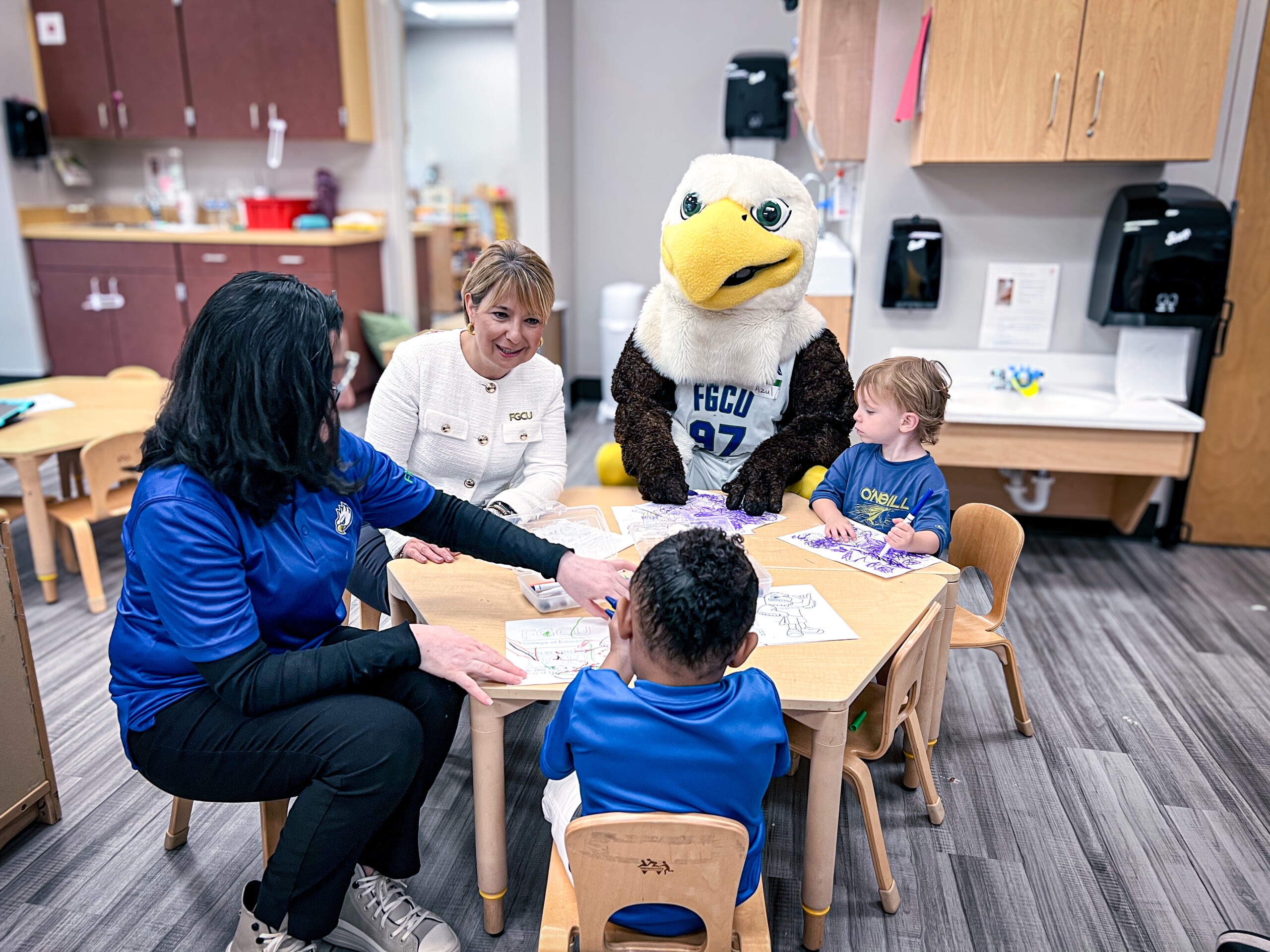FGCU president Aysegul Timur and Azul work with children at the new Early Learning Childhood Development Center, a child care center in East Naples.