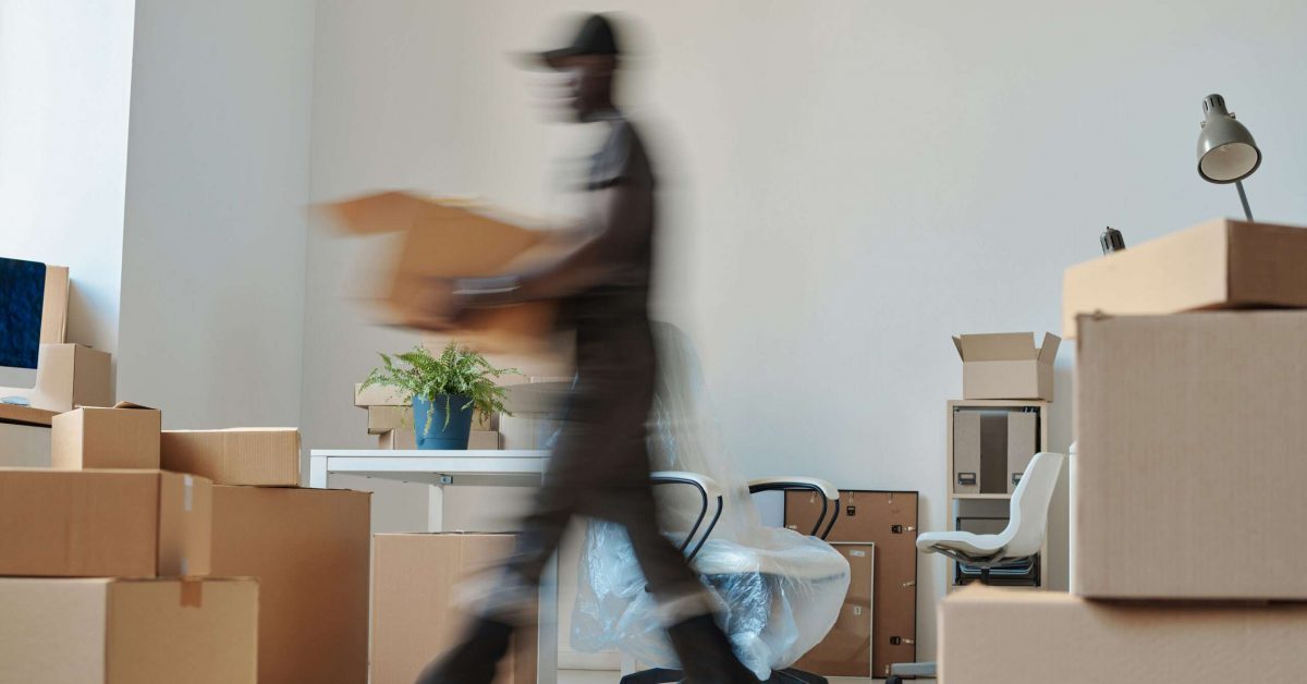 Worker carrying boxes during relocation