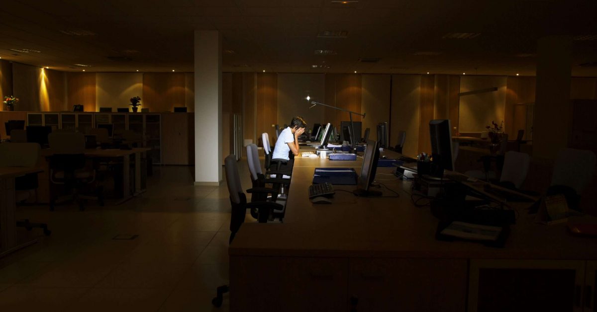 Tired Woman Using Computer In Dark Office