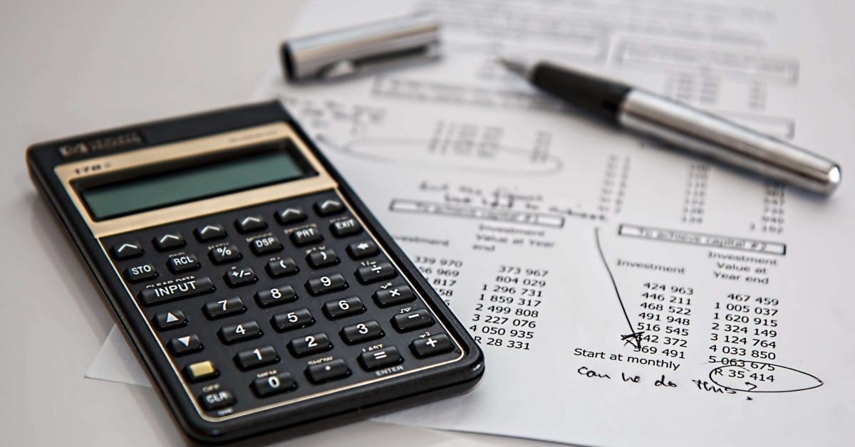 black-calculator-near-ballpoint-pen-on-white-printed-paper-53621