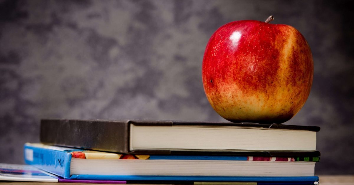 close-up-of-apple-on-top-of-books-256520
