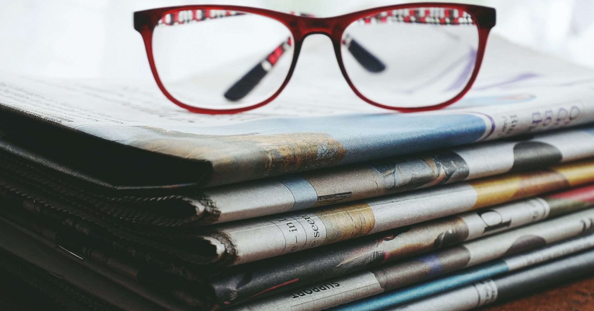 red-framed-eyeglasses-on-newspapers-3886870