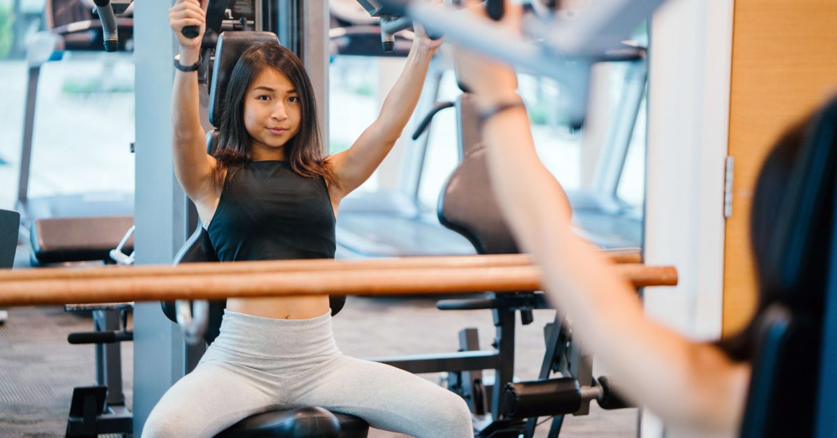 woman-in-black-sleeveless-crop-top-and-white-leggings-using-1111304